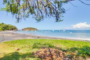 a beach with a bunch of boats in the water at The Cove 3/4 in Coco