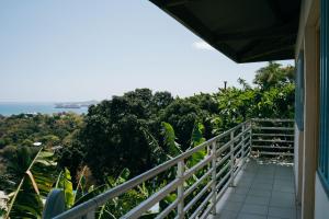 a balcony of a house with a view of the ocean at Gîte Rose Doudou in Mamoudzou