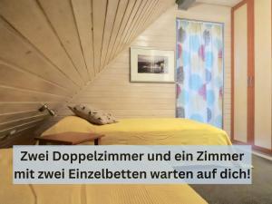 a bedroom with a bed with a wooden wall at Entspannung in der Natur mit Seeblick und Sauna - Ferienhaus Felix von Mein-Seepark in Kirchheim