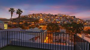 a view of a city at night from a balcony at Casa Sabai in Las Palmas de Gran Canaria