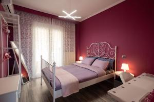 a bedroom with purple walls and a bed with a white frame at F & B Collection - Seaview 2 Bedroom Flat in Thessaloniki