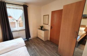 - une chambre avec un lit, une fenêtre et une porte dans l'établissement Hanni, wenige Minuten zum Strand, à Warnemünde