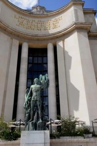 a statue of a man in front of a building at Eiffel Tower Oasis 30m from Eiffel Tower in Paris