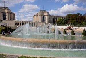 a water fountain in front of a large building at Eiffel Tower Oasis in Paris