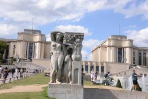a statue of two women in front of a building at Eiffel Tower Oasis 30m from Eiffel Tower in Paris