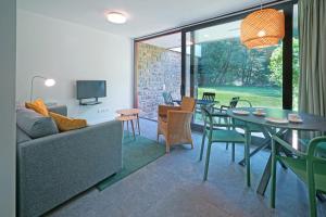 a living room with a couch and a table and chairs at Domaine Long Pre in Stavelot