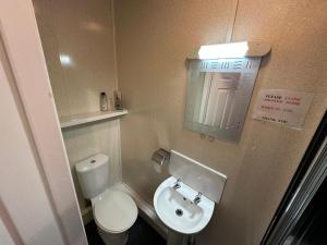 a small bathroom with a toilet and a sink at Ocean Road Rooms in South Shields