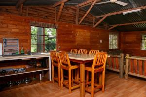 a kitchen with a table and chairs in a cabin at Crocodile Nest B&B in Nelspruit
