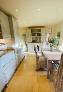 a kitchen with a table and chairs in a kitchen at Little Campden House in Chipping Campden +28 photos