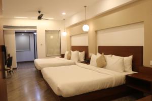 HOTEL KADAMB TREE客房内的一张或多张床位