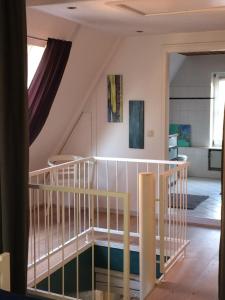 a room with a staircase and a kitchen in a house at Lüttje Ferienhuus in Tönning