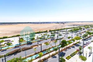 an aerial view of a parking lot with a beach at Lavish Studio In Oasis in Al Qurayyah