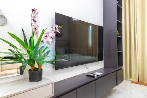 a flat screen tv on a wall in a living room at Lavish Studio In Oasis in Al Qurayyah