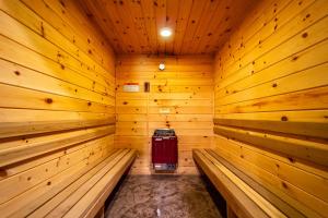 a wooden sauna with a red cooler in it at Large Luxury Home, Close to Whiteface, Lake Placid in Wilmington