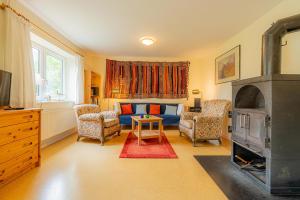 a living room with a couch and a fireplace at Haus am Kirchenweg in Katharinenheerd