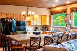 a kitchen with a large table and chairs in it at Large Luxury Home, Close to Whiteface, Lake Placid in Wilmington