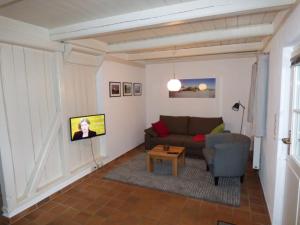 a living room with a couch and a table at Wasserkoog 22 in Tetenbüll