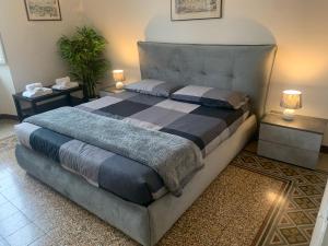 a large bed in a room with two night stands at Maison Cavalleggeri in Rome