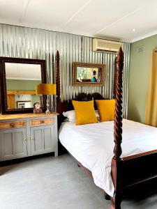 a bedroom with a bed and a large mirror at Terebinte Bed & Breakfast in Durban