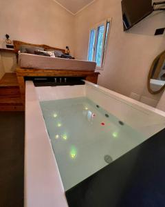 a room with a large jacuzzi tub with lights in it at Nakupenda Relais 