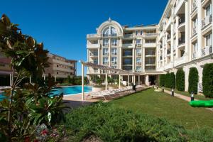 a large building with a pool in front of it at Rena Hotel - All Inclusive in Sunny Beach