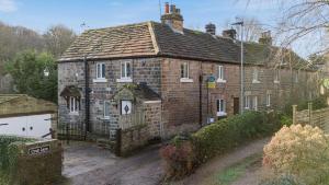 an old brick house with a gate in front of it at Scenic 2 bedroom Cottage in Hill Top