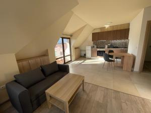 a living room with a couch and a table at ZaraApartHotel in Sofia