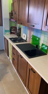 a kitchen with a sink and a stove top oven at Violet Home Irpinia in Montemarano