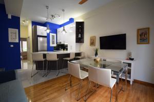 a kitchen and dining room with a table and chairs at Piraeus Blue in Piraeus