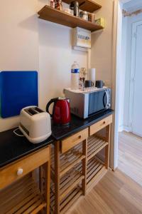 a kitchen with a counter with a microwave and a toaster at Well located apartment in Paris in Paris