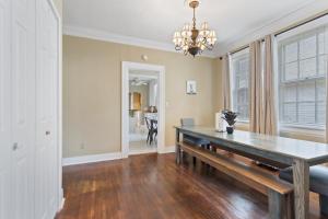 a dining room with a table and a couch at Mins to Zoo - Capitol Heights Hideaway in Montgomery