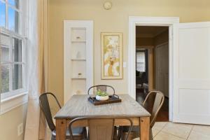 a dining room with a wooden table and chairs at Mins to Zoo - Capitol Heights Hideaway in Montgomery