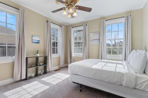 a bedroom with a bed and a ceiling fan at Mins to Zoo - Capitol Heights Hideaway in Montgomery +55 photos