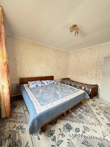 A bed or beds in a room at Гостевой дом Шынар