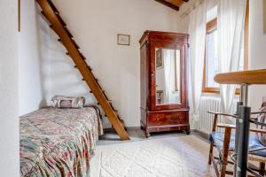 a bedroom with a bed and a dresser and a mirror at A casa da nonna Elisa in Castel del Piano