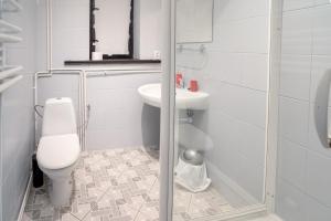 a white bathroom with a toilet and a sink at VacationClub - Ski Lodge Szczyrk Pokój 1 & 2 in Szczyrk