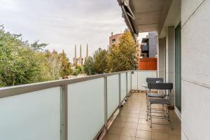 a balcony with chairs and a view of a city at 4207 - AB Sant Adria de Besos in Barcelona