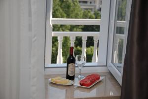 a bottle of wine next to a glass of wine at Old Metekhi Hotel in Tbilisi City