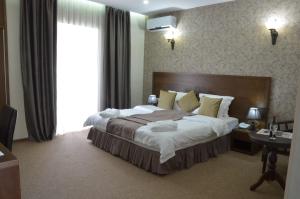 a hotel room with a bed and two nightstands at Old Metekhi Hotel in Tbilisi City