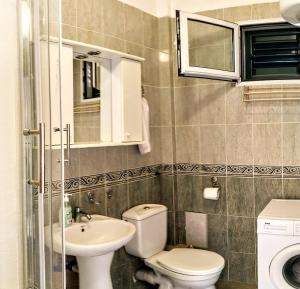 a small bathroom with a toilet and a sink at Apartments "Belle Vue" in Herceg-Novi