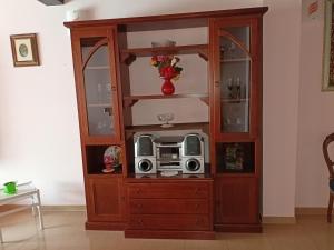 a wooden cabinet with a microwave in it at Villa ILIRIA in Ripa