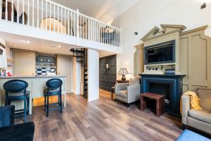 a living room with a bar and a staircase at Luxury One Bedroom Mezzanine in Paddington in London