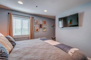 a bedroom with a bed and a tv on the wall at Condo in the Heart of Nashville - unit794 in Nashville