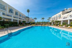 a large swimming pool in front of a building at Newly Refurbished 2 BDRM Amazing Complex w Pools in Marbella