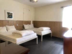 Postel nebo postele na pokoji v ubytování iDorm B&B - idorm Mỹ