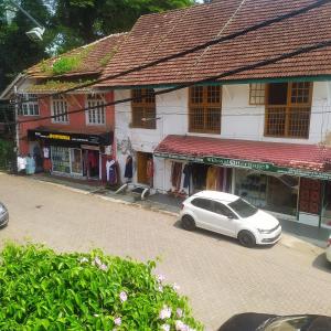 a white car parked in front of a building at Sundance Beach Villa on Princess Street in Cochin