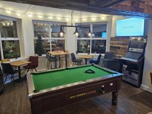 a room with a pool table and a bar at The Garden Bar Rooms in Baildon