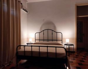 een slaapkamer met een bed en 2 bijzettafels bij Il Patio in Sampieri
