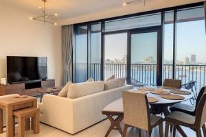 a living room with a white couch and a table at Key View - Creek Edge T2 in Dubai