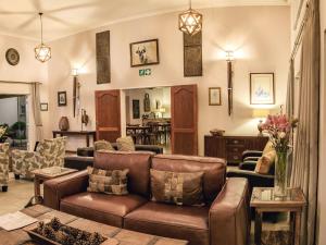 a living room with a couch and a table at Monkey Thorn Guest Lodge in White River